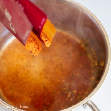 Then in a separate small pot, boil 13.5 fl. oz or 400 ml water with 2 packets of the red powder sauce. Mix the water and powder together until combined.