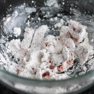 In a separate bowl or on a large plate, add cornstarch and evenly coat each slice of marinated beef in the starch ensuring no bald spots. Transfer the coated pieces to a large plate.