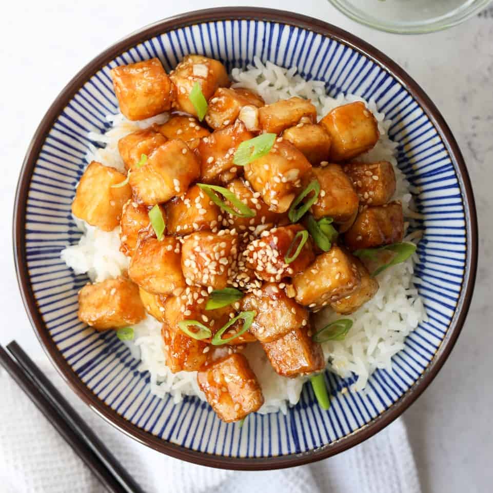 Remove and transfer tofu with sauce onto a large serving plate. Garnish with green onions and sesame seeds and enjoy!