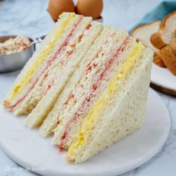 Remove the plate or plastic wrap, slice off crusts on all four sides with a sharp serrated knife. Slice diagonally and enjoy!