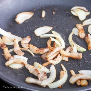 Heat a large pan on medium heat, fry pork belly until cooked for about 1 minute. Add onions and sauté until translucent. 