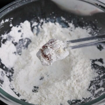 Dredge the chicken in cornstarch mixture.