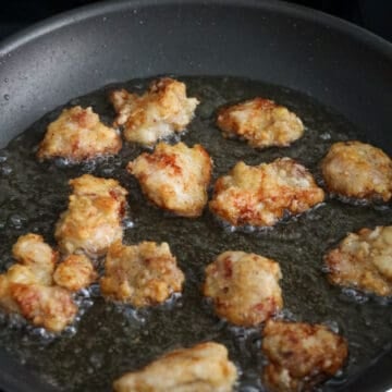 Fry the chicken in hot oil until golden and crispy.