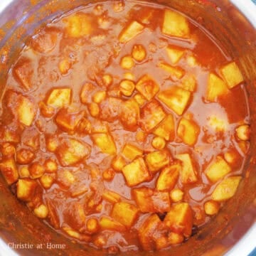 Mix in tomato sauce and tomato paste until combined with potatoes. Then add chickpeas and toss gently. Stir in cold water and simmer for 2 minutes.