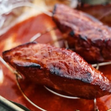 Broil it for 5 minutes by raising the temperature to 500 degrees F until the edges become charred. Make sure the internal temperature of the pork reaches 145 degrees F.