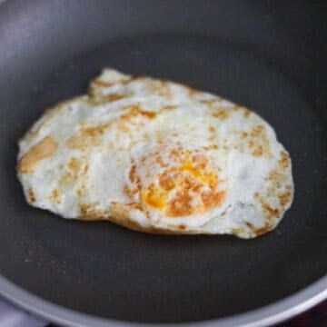 Heat vegetable oil in a small pan on medium heat. Fry your egg easy over for 3-5 minutes depending on how jammy you like your egg.