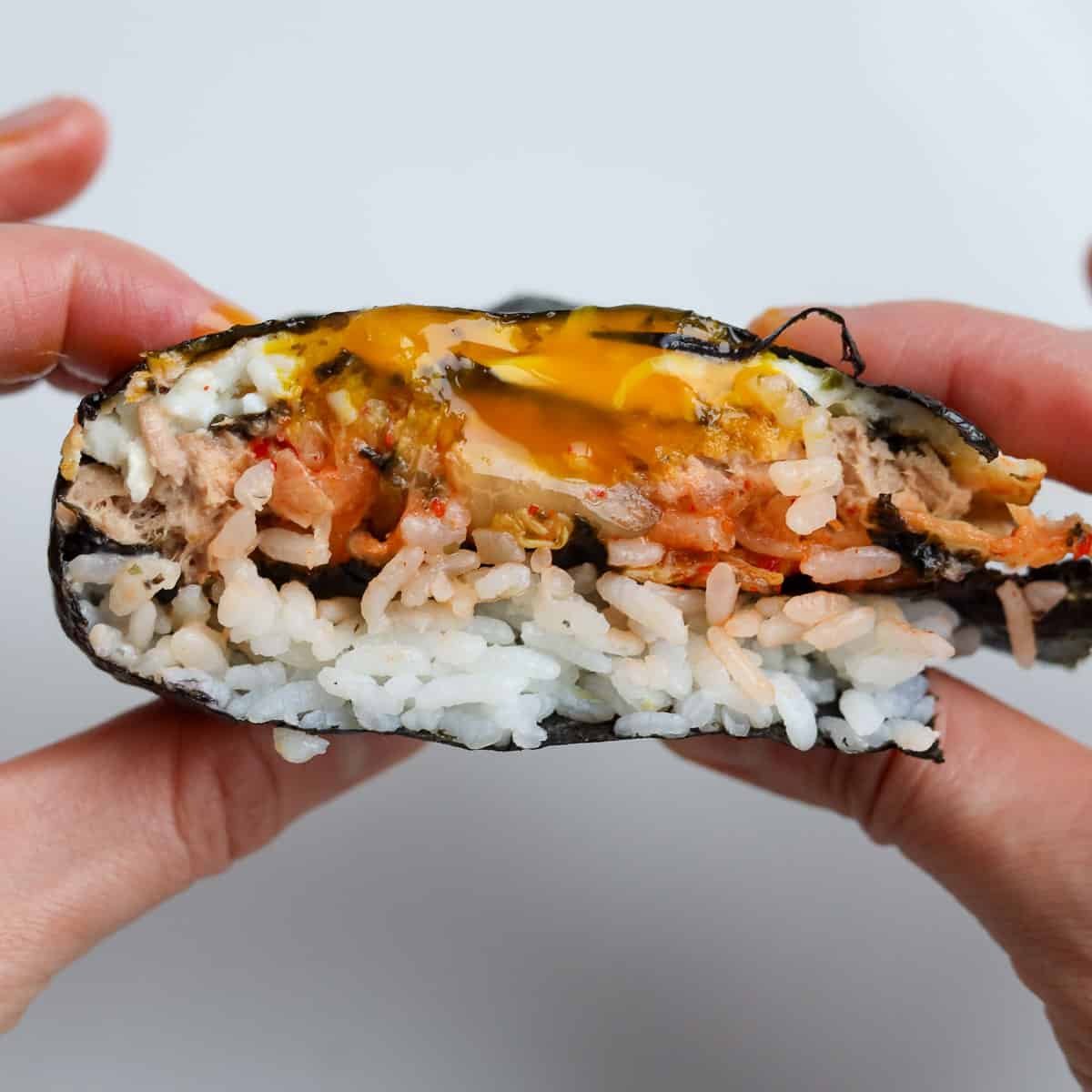 Fold the kimbap starting from the bottom left quadrant upwards until you form a square. Enjoy immediately!