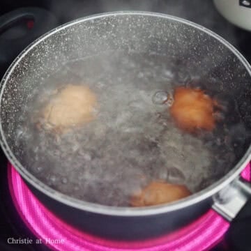 Bring a small pot of water to boil on medium-high heat. Gently lower room temperature eggs into the boiling water. Reduce to medium heat for a rolling boil. Set a timer and boil for 6:30 minutes. For hard boiled eggs, boil for 11 minutes.