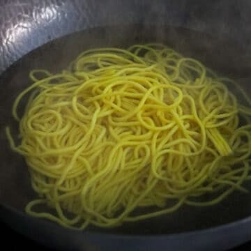 Blanch noodles in boiling water until loosened and strain