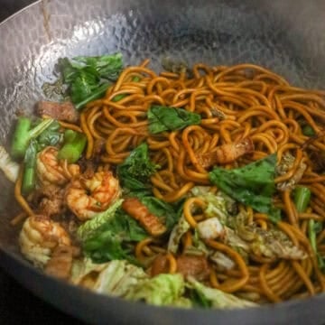 Add cabbage, Chinese broccoli, and chicken stock. Toss until combined and the noodles have mostly absorbed the stock. Transfer the noodles to a large serving plate and enjoy!