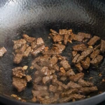 In a large pot on medium heat, heat vegetable oil and fry beef until browned.