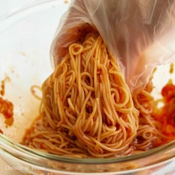 Add strained noodles to your sauce and mix well with clean hands