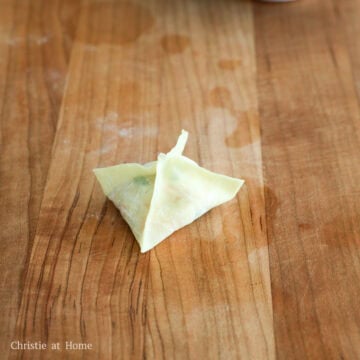 Then seal the remaining corners with the pinched ones. Press edges firmly to prevent leaks, especially the tip of the wonton. Repeat this process until there is no more filling left.