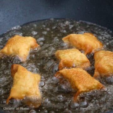 Heat vegetable oil in a large pan on medium heat, around 325 degrees F.  Deep fry the wontons 6-7 pieces at a time until golden and crispy, about 1.5 to 2 minutes in total. Flipping over halfway.