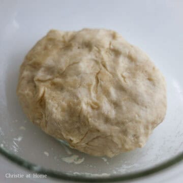 In a large mixing bowl, whisk together all-purpose flour and salt. Make a well in the middle of the flour. In a small saucepan, heat ½ cup or 125 ml vegetable oil on medium-high heat until it begins to smoke. Carefully pour the hot oil into the well and let it bubble for 1 minute. Then whisk the flour and oil together. Add water and mix together with a silicone spatula. Knead the dough into a ball with clean hands.