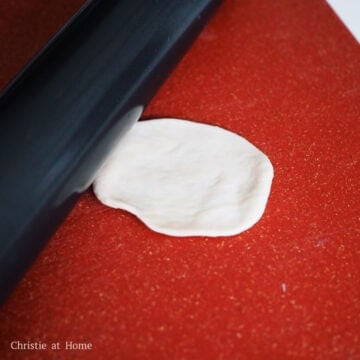 Roll each ball of dough into a flat 4-inch wide circular wrapper using a rolling pin. Cover the dough wrappers with a clean tea towel to keep them moist.