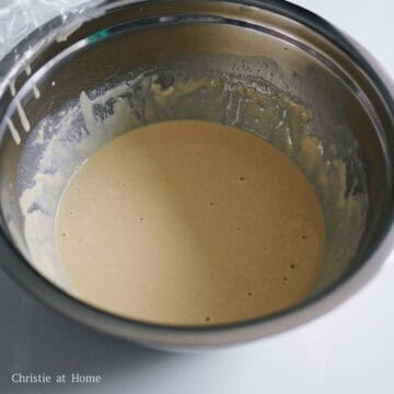 In a large mixing bowl, sift and whisk all-purpose flour, self rising flour, baking soda, and salt. Then in a medium sized bowl, whisk together warm milk, dry active yeast, vanilla extract and sugar. Allow the yeast to dissolve completely. Whisk the milk mixture into the dry ingredients. Crack an egg into the batter and whisk just until combined and do not over mix.