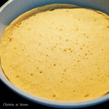 Cover the pan with a lid. Let this cook until bubbles form all over the pancake, about 2-3 minutes.