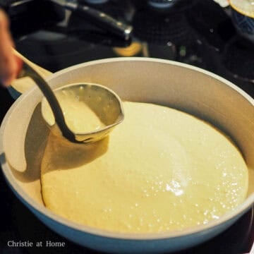 Ladle the batter into the pan and spread it out into a even pancake.