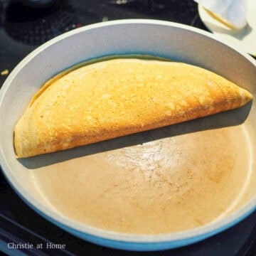 Remove the lid and with a large spatula, fold one side of the pancake over the other side to create a semi-circle.