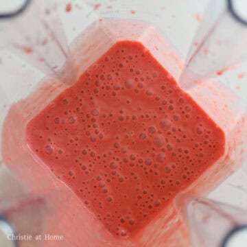 Fresh strawberries being measured, hulled, and blended with condensed milk until smooth.