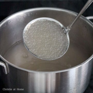 Tapioca pearls being cooked in boiling water, then simmered and left to soak until translucent.