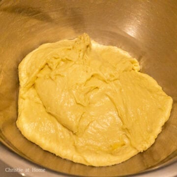 Place dough back into a clean greased mixing bowl to proof. Cover and allow this to rest in a warm area for 1.5 hours until it doubles in size.