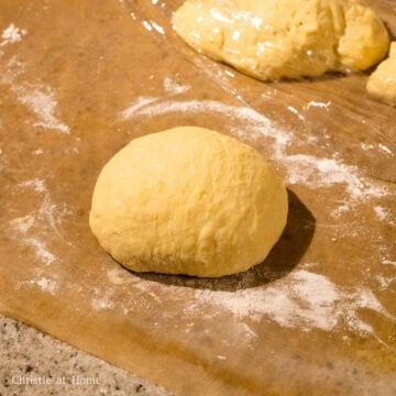 Once it has doubled, divide dough into 3 equal portions. Roll into balls.