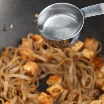 Toss in strained rice noodles with the noodle sauce. Add ¼ cup of water and mix with noodles. Cook for 5-7 minutes and taste noodles to check if they are chewy and soft enough. If not, add another ¼ cup water and cook until noodles to desired texture.