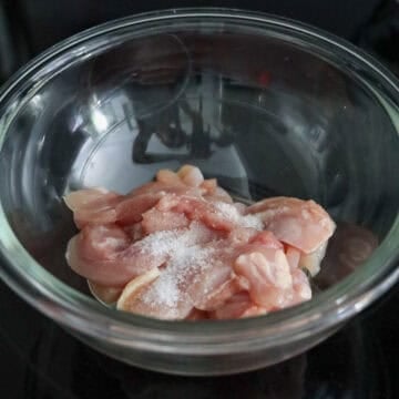 Season sliced chicken thighs with salt. Set aside.