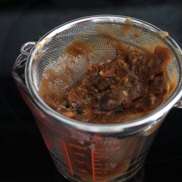 To make tamarind concentrate: submerge tamarind pulp in ⅓ cup hot boiling water and soak for 3 minutes. Let it cool and then with clean hands, squeeze and massage the pulp until it dissolves in the water. Strain as much as the tamarind paste through a fine sieve, discarding the seeds reserving the paste. This is your tamarind paste.