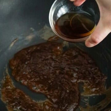 To make the noodle sauce: In a large non-stick wok on low medium heat, add palm sugar. Caramelize for 2-3 minutes while stirring. Mix tamarind paste with caramelized palm sugar. Then mix in fish sauce. Remove sauce from the pan and set aside in a small bowl.