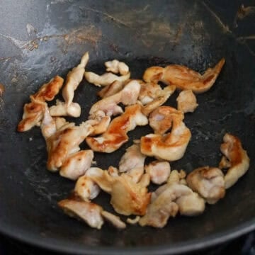 Over medium heat, add 2 teaspoon vegetable oil into the same pan and cook sliced chicken. Remove and set aside.
