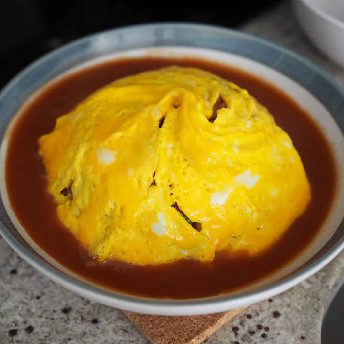 Once sauce has thickened, remove off heat and pour half of it around or on top the omelette fried rice. Enjoy!