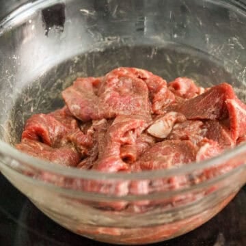 slice beef on a bias into ¼-inch thick pieces and marinate for 15 minutes. set aside