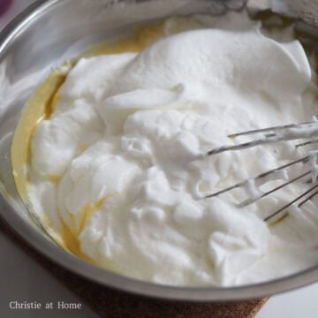 Gently whisk a large dollop of the meringue into the batter until combined to loosen it up. Then add another dollop and whisk again. Then pour the rest of the meringue in and gently whisk until it's just combined. Don't over mix.