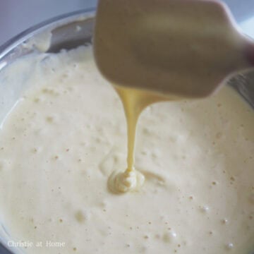 Now switch to a spatula to mix and gently fold the batter, scraping the base of the bowl to ensure it's thoroughly mixed.