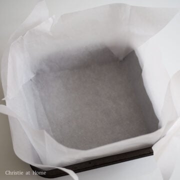 Preheat the oven to 300 degrees F. Then line a seamless 20-cm / 8-inch square baking pan with a large sheet of parchment paper so the paper sits a few inches taller than the pan. This will shape the cake as it rises.