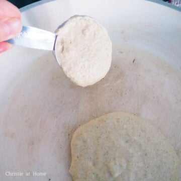 Evenly grease a large non-stick pan with butter and bring to medium heat. Pour ¼ cup or 60 ml of the pancake batter into the pan.