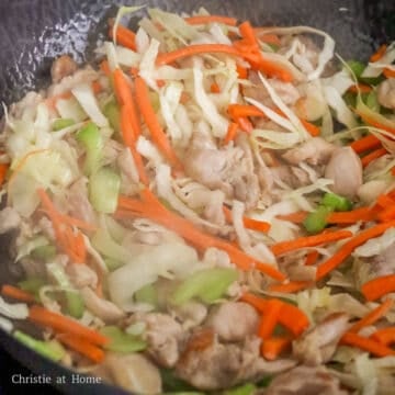 Then toss in carrots, celery, cabbage and fry until softened. Push everything to the side of the pan.