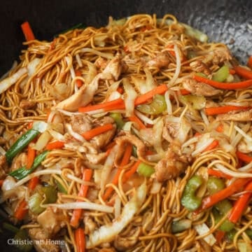 Add remaining vegetable oil into the empty space. Toss in noodles with noodle sauce. Stir fry until noodles are coated in sauce, about 30 seconds. Toss in bean sprouts and green onions. Fry for 10 seconds. Serve and enjoy!