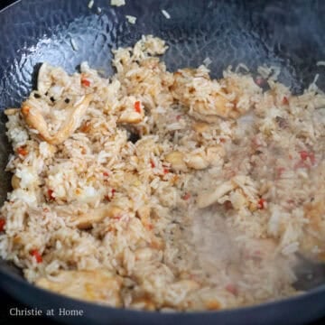 Push everything to the side. Add more oil if needed into empty space. Toss in rice and sauce. Note: it is fine if your rice is a bit moist as this fried rice is more on the saucier side than dry.