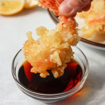 In a small bowl, combine Tsuyu soup concentrate and cold water to make the sauce. Dip one shrimp tempura into the sauce.
