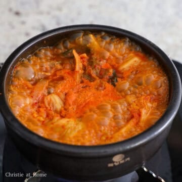 Mix in anchovy stock, kimchi brine, gochugaru, and fish sauce. Simmer uncovered for 15 minutes on medium heat. Then taste test the broth and if needed, add another ½ teaspoon or 2.5 ml of fish sauce for a deeper flavor.Â