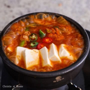 Add sliced tofu on top of the stew. Season with sesame oil. Garnish with chopped Korean chili peppers and enjoy hot with rice.Â