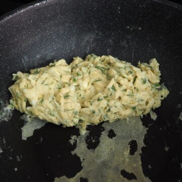 Once the eggs take shape, stir and scramble the eggs. Then fold them over.