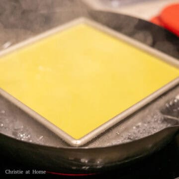 Then pour the pandan custard over top. Gently tap the baking pan on a even surface to remove any air bubbles. Transfer the baking pan back into the steamer ensuring there's enough water in the wok or steamer pot.