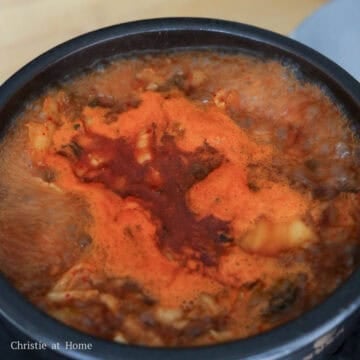 Mix in stock and kimchi juice. Cover and bring to a boil on medium-high heat. Once it reaches a boil, reduce to medium heat and simmer for 20 minutes, uncovered. Stir occasionally.