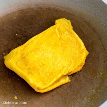 Then flip that omelet on top of the other one to create a layered effect. Fry the omelet until cooked through on both sides. Remove and set aside.