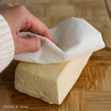 Remove the tofu from the package and strain out excess water. Pat the tofu block dry with paper towels to remove excess moisture.